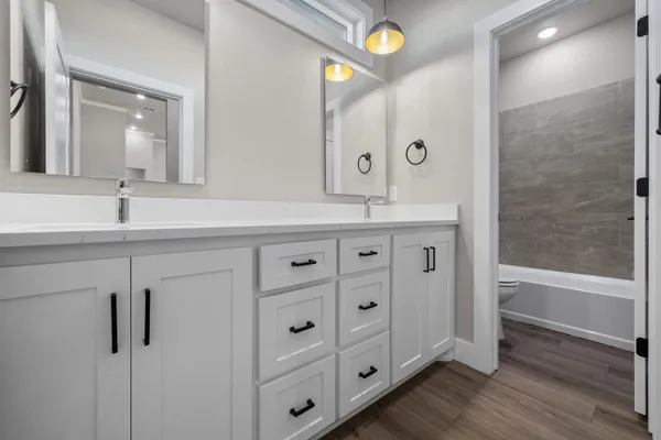 a white toilet and tub sitting next to a bathroom sink