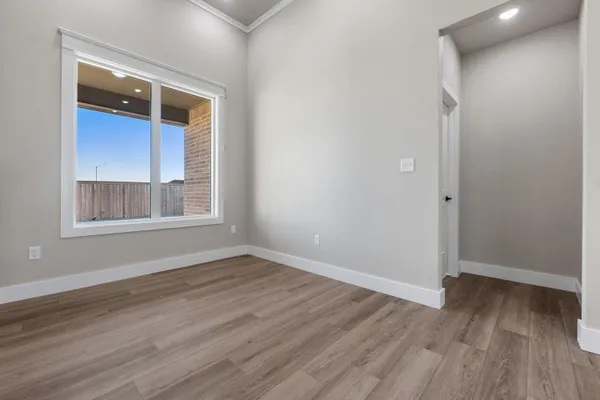 a view of a kitchen with a refrigerator and a stove top oven