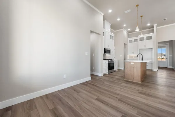 a kitchen with granite countertop a sink and a stove top oven