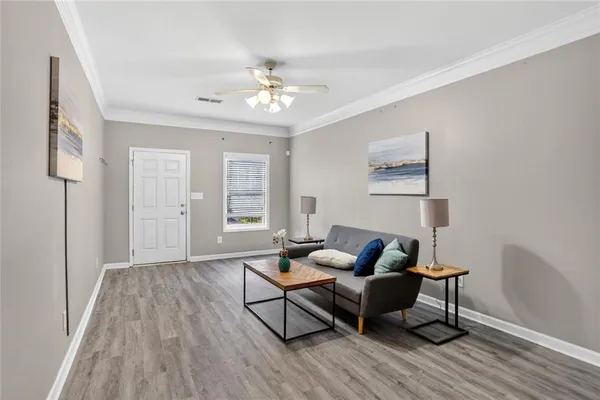 a living room with furniture and wooden floor