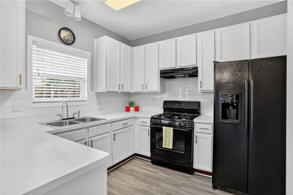 a kitchen with a sink stove and refrigerator
