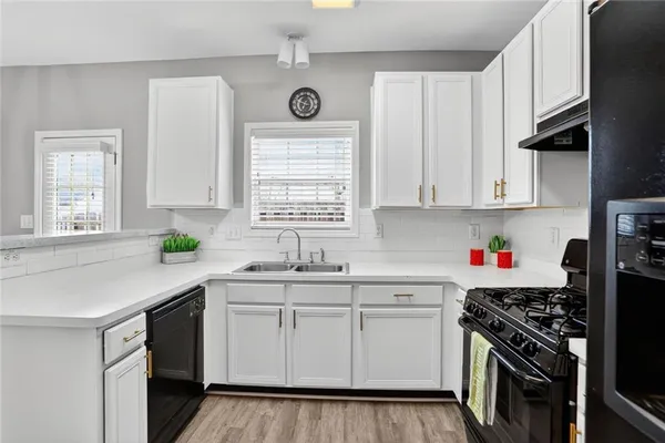 a kitchen with a sink stove top oven and cabinets