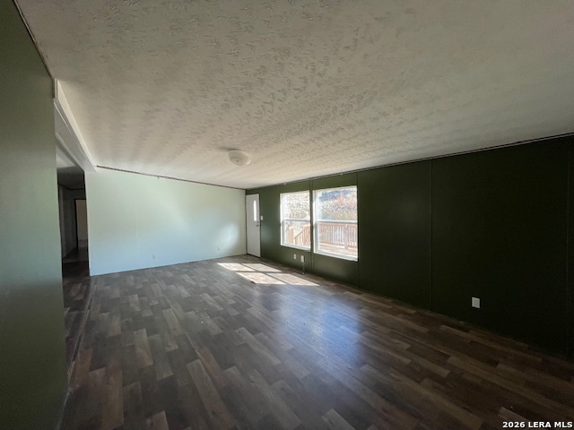 207 Hopi Trail Bandera, TX 78003 - Photo 16 of 21 an empty room with wooden floor and windows