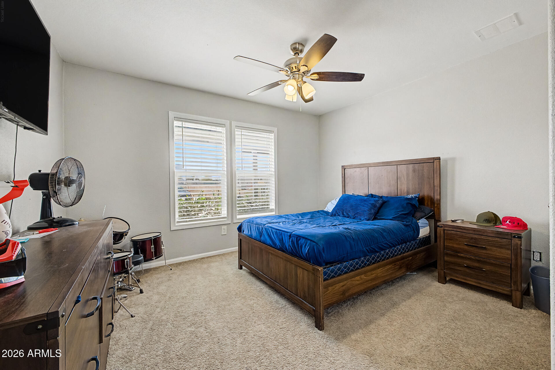 22417 West Dove Valley Road Wittmann, AZ 85361 - Photo 23 of 53 a bedroom with a bed and a chandelier
