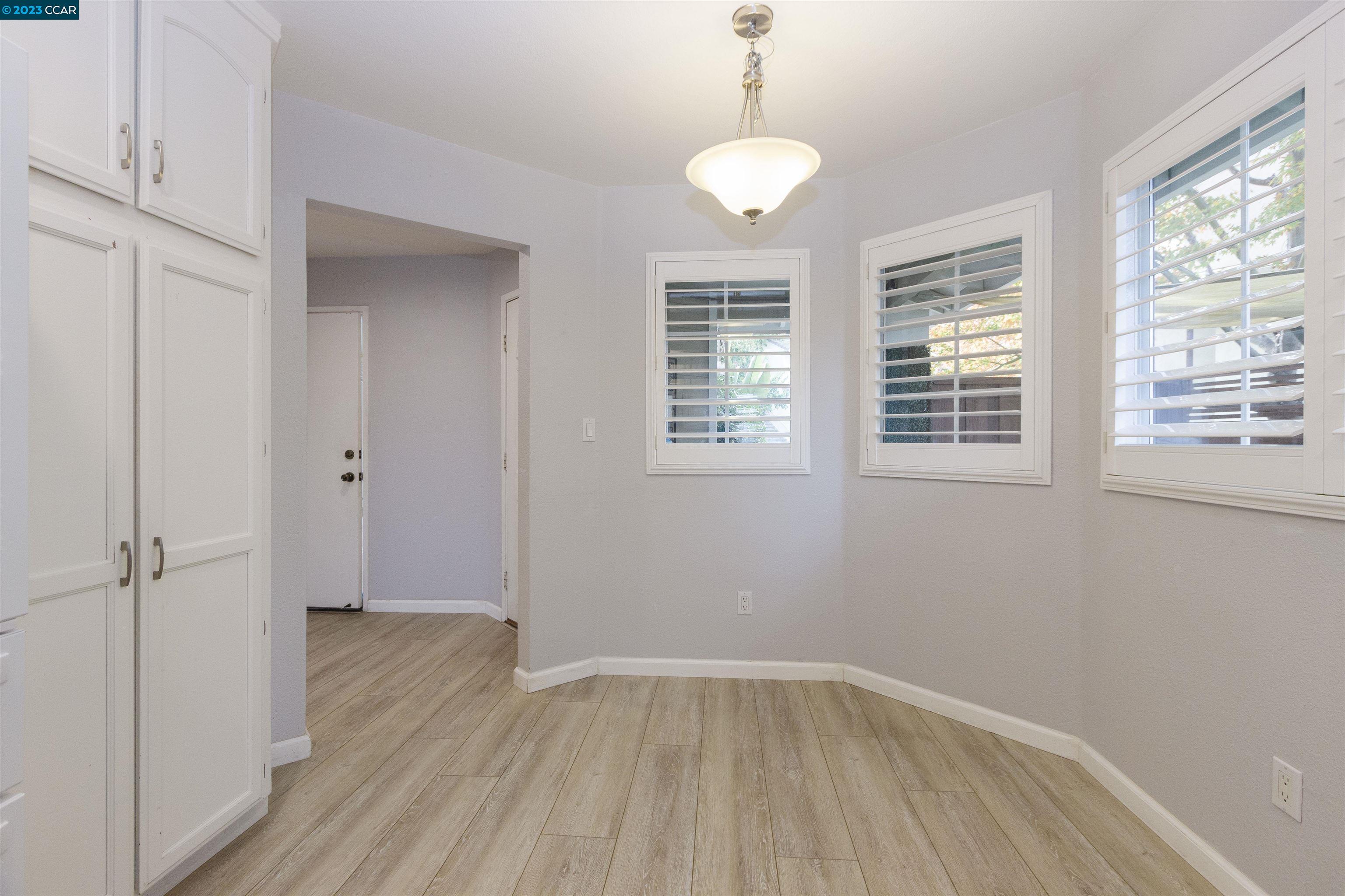 5291 Pebble Glen Drive Concord, CA 94521 - Photo 3 of 21 a view of an empty room with wooden floor and a window
