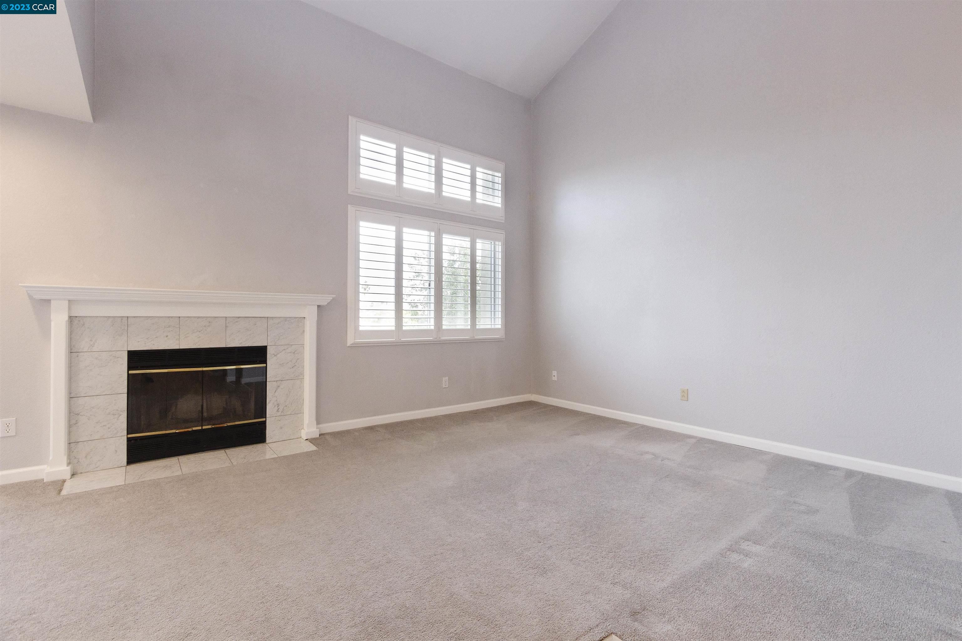5291 Pebble Glen Drive Concord, CA 94521 - Photo 6 of 21 an empty room with windows and fireplace