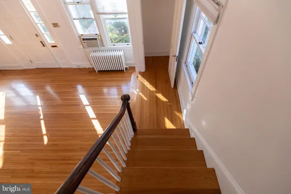 a view of staircase with white walls and railing