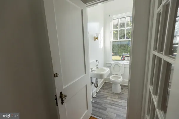 a view of empty room with a window and wooden floor