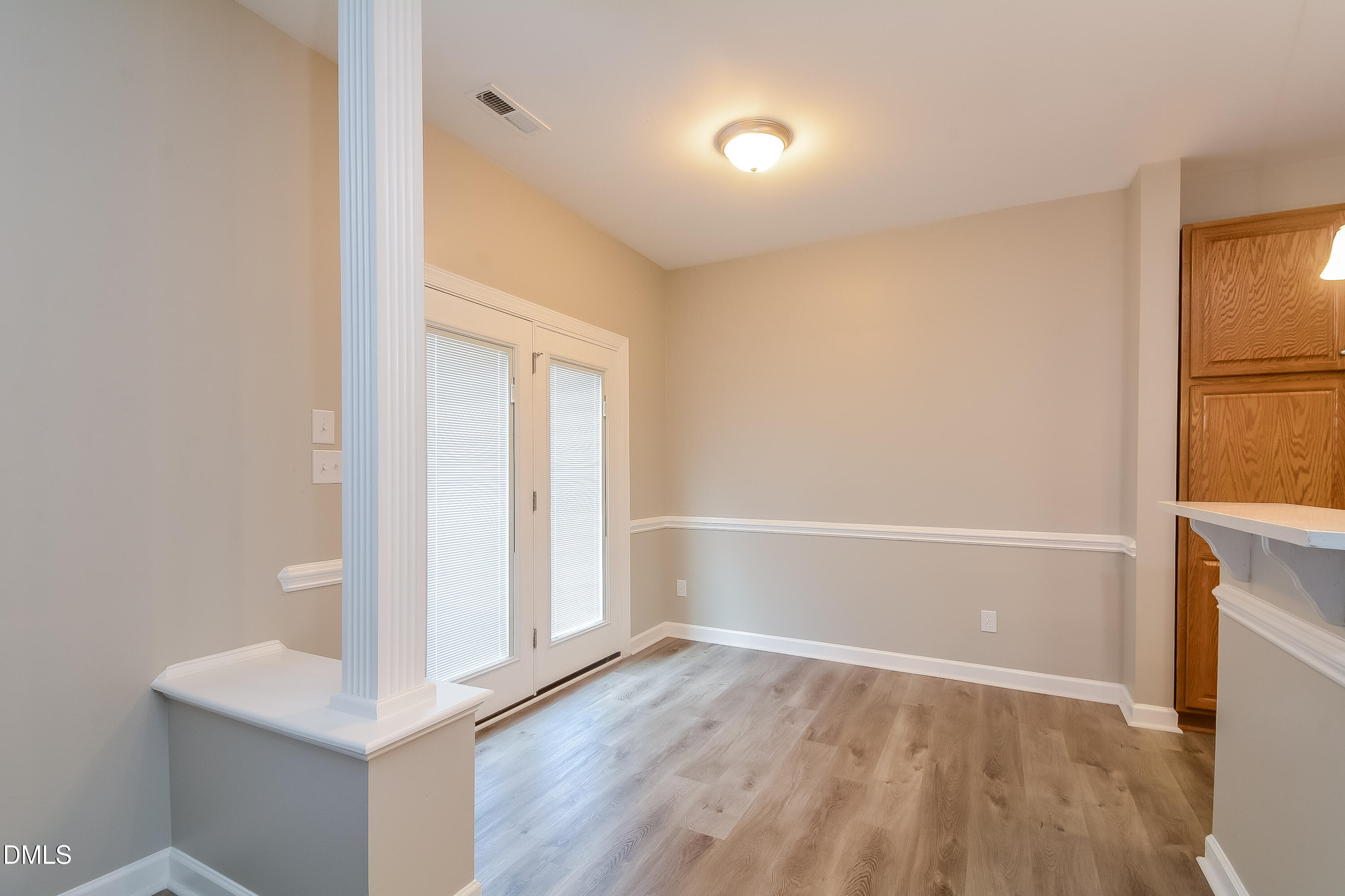 2231 Lazy River Drive Raleigh, NC 27610 - Photo 4 of 17 a view of an empty room with wooden floor and a window