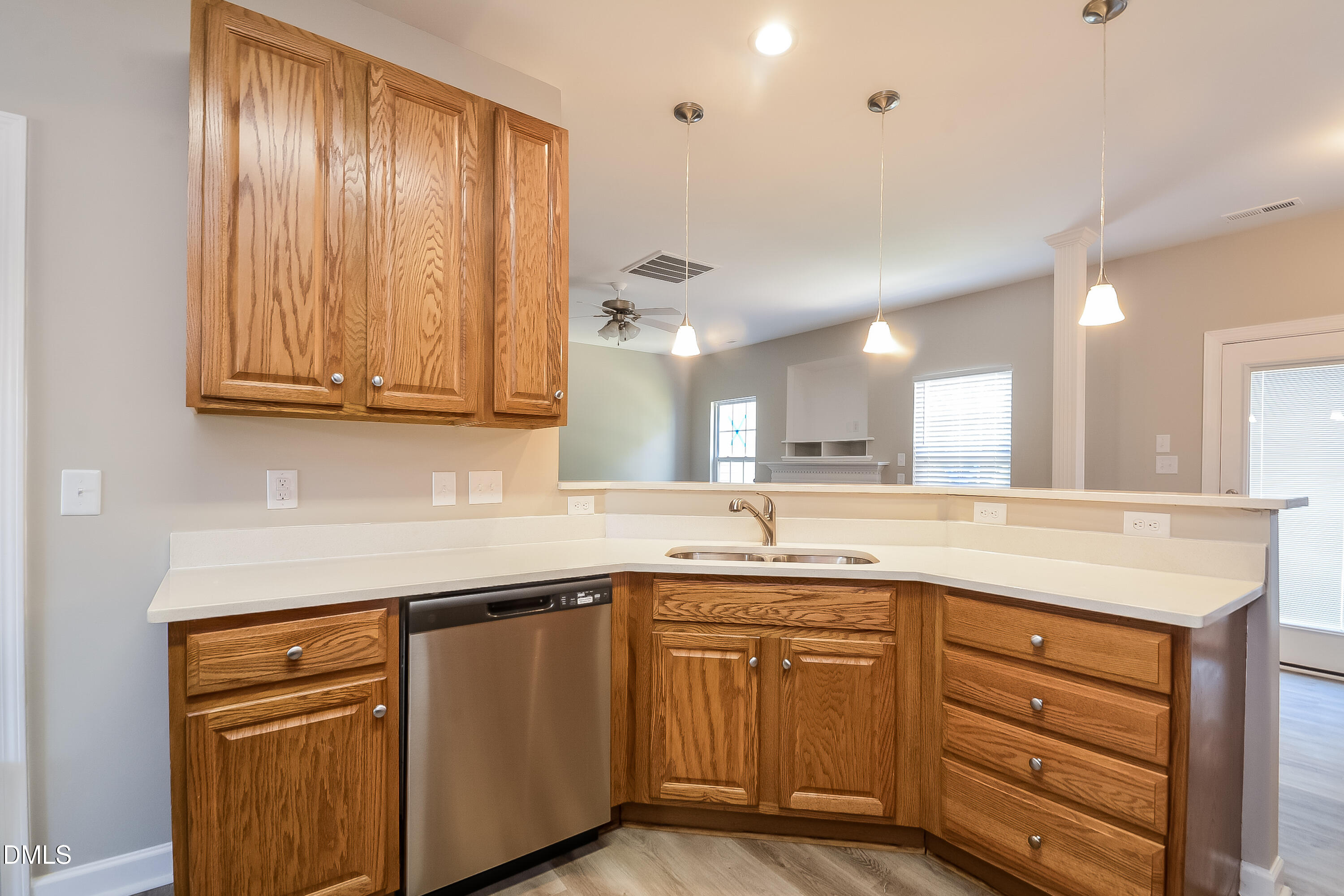 2231 Lazy River Drive Raleigh, NC 27610 - Photo 5 of 17 a kitchen with stainless steel appliances granite countertop a sink and cabinets with wooden floor