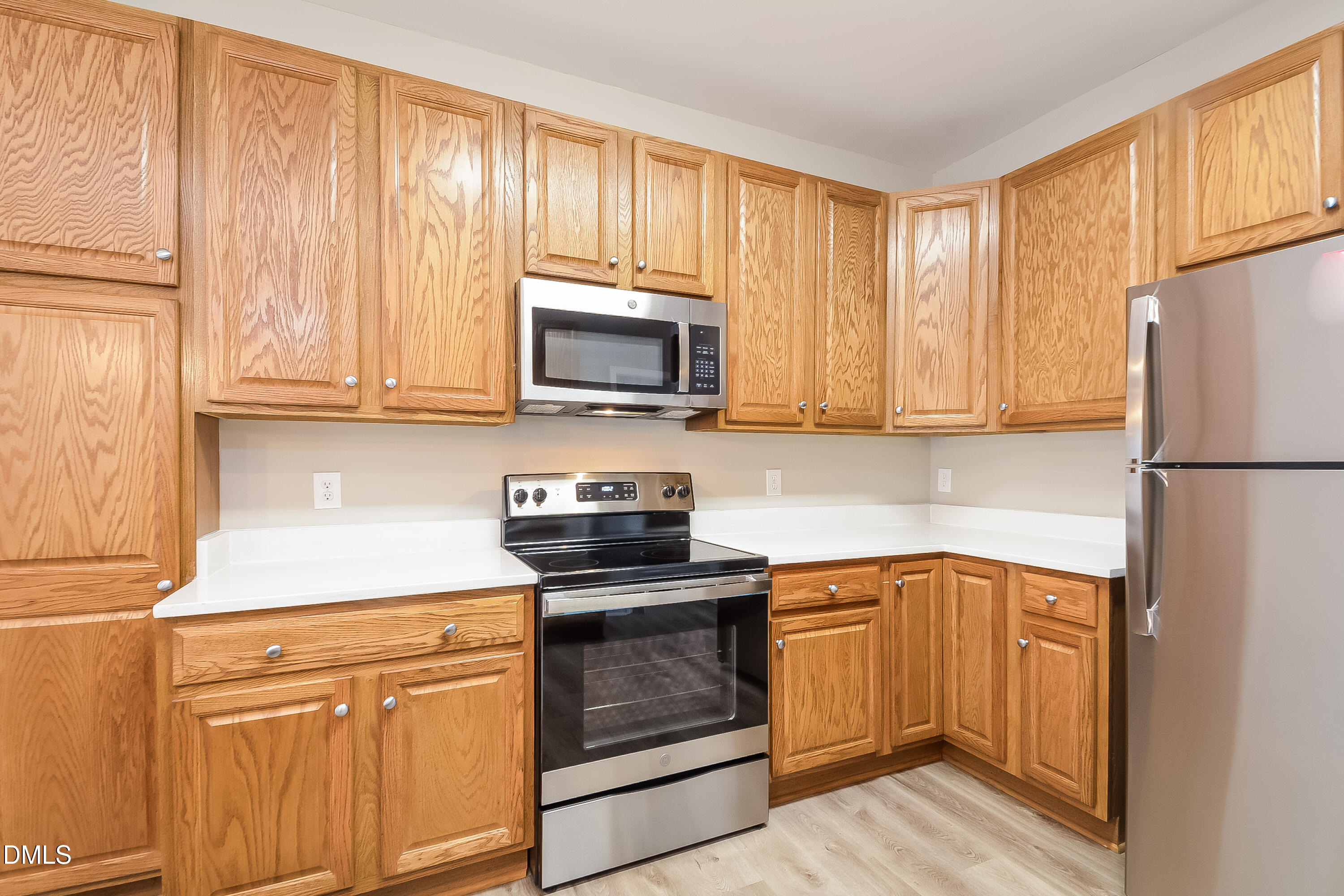 2231 Lazy River Drive Raleigh, NC 27610 - Photo 6 of 17 a kitchen with a sink stove and microwave