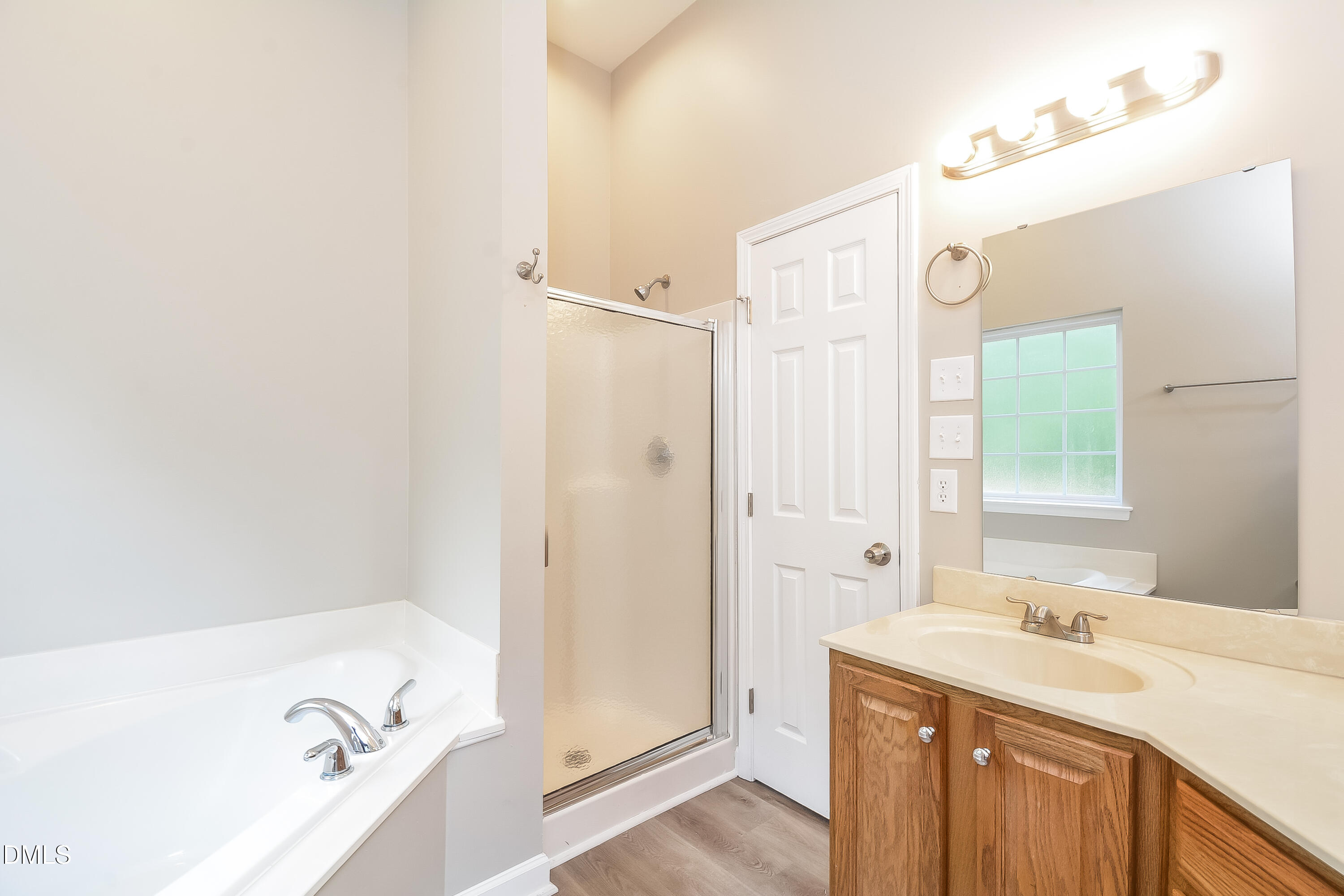 2231 Lazy River Drive Raleigh, NC 27610 - Photo 10 of 17 a bathroom with a tub sink and mirror