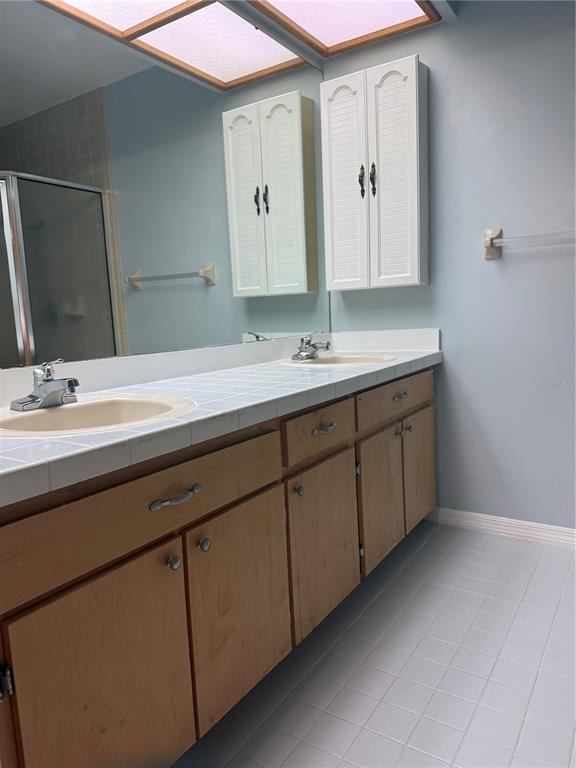 11711 Ridgeview Lane Seminole, FL 33772 - Photo 14 of 30 a bathroom with a double vanity sink and mirror