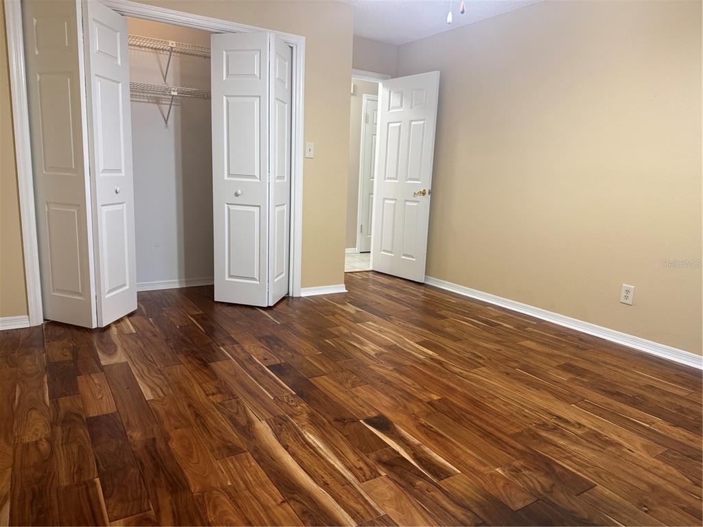 11711 Ridgeview Lane Seminole, FL 33772 - Photo 16 of 30 a view of an empty room with wooden floor