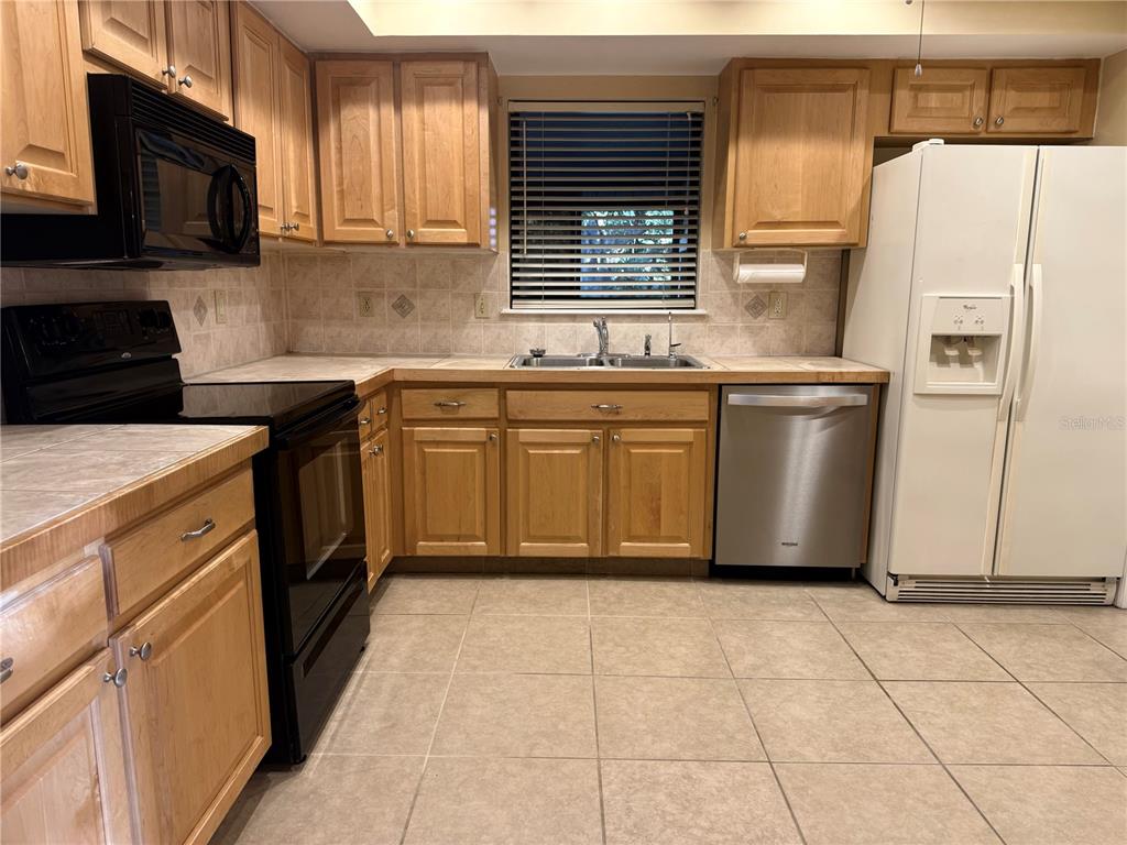 11711 Ridgeview Lane Seminole, FL 33772 - Photo 6 of 30 a kitchen with stainless steel appliances granite countertop a stove a sink dishwasher and a refrigerator