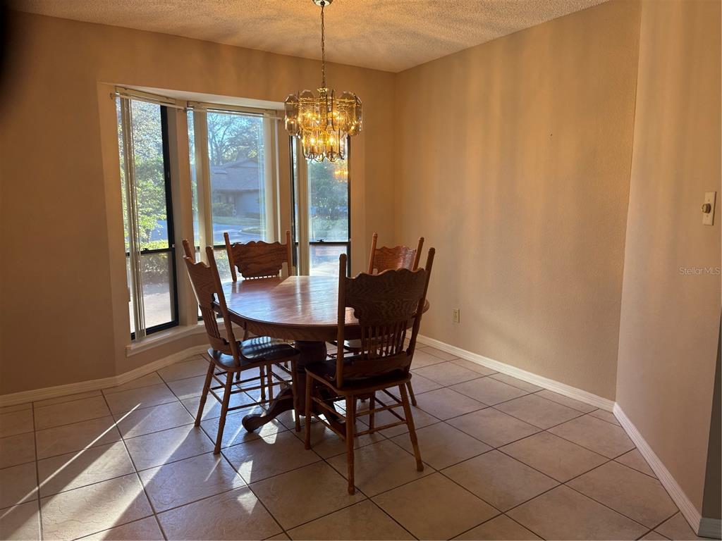 11711 Ridgeview Lane Seminole, FL 33772 - Photo 8 of 30 a view of a dining room with furniture and window