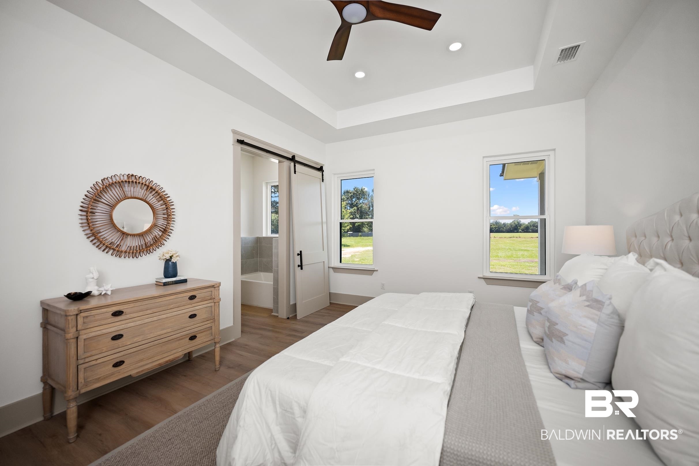 13111 Gopher Court Elberta, AL 36530 - Photo 15 of 41 Recessed lighting illuminating a spacious room with a tray ceiling and a ceiling fan