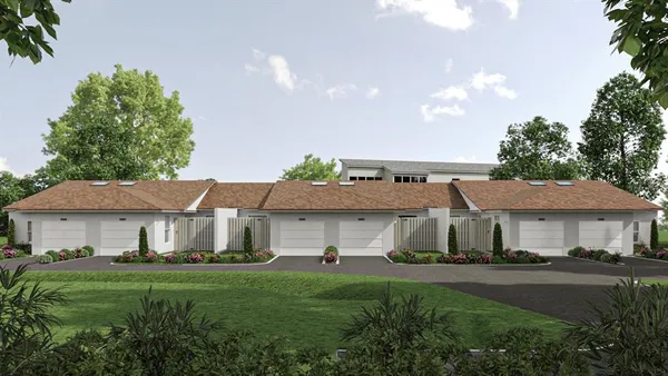 a front view of a house with a garden