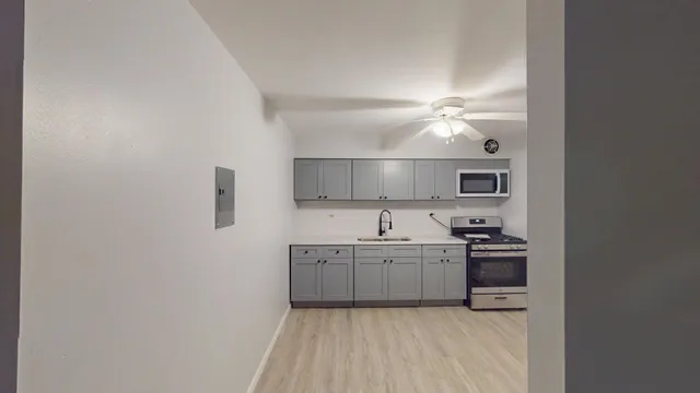 a kitchen with cabinets a sink and appliances