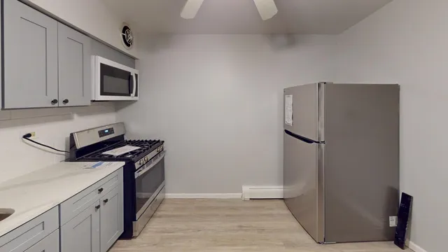 a kitchen with stainless steel appliances a refrigerator stove and microwave