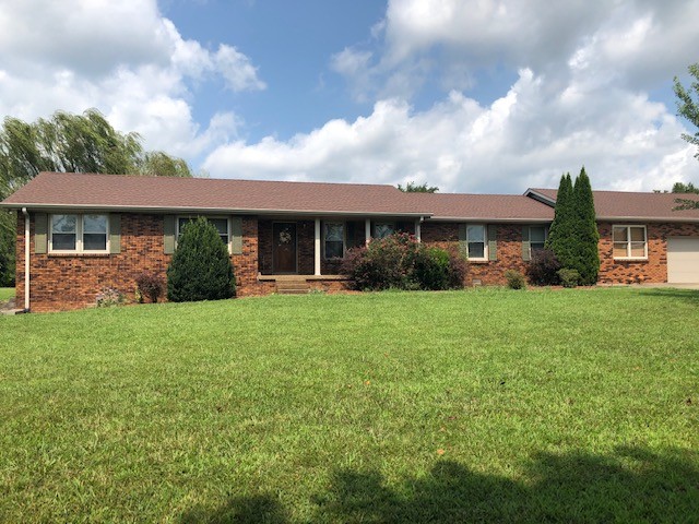 a front view of house with yard and green space