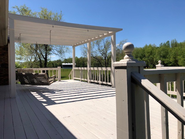 3270 Ott Wilson Road Springfield, TN 37172 - Photo 6 of 7 a view of a patio with table and chairs under an umbrella with wooden floor