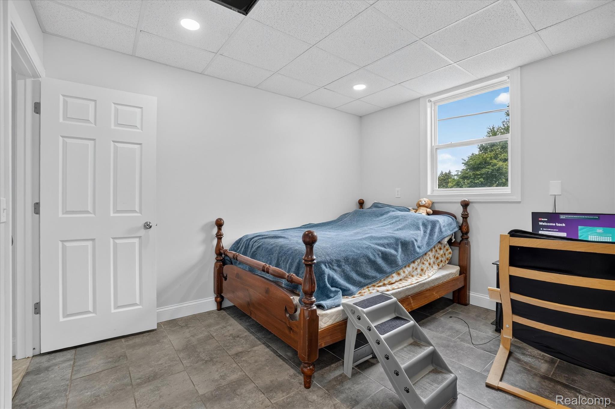 6524 Kelly Road Flushing, MI 48433 - Photo 23 of 47 Room featuring a window with natural light, recessed lighting, white walls, a drop-tile ceiling, and tile flooring