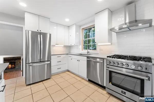 a kitchen with cabinets appliances and a window