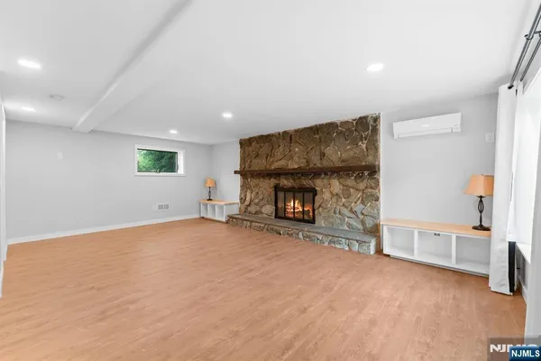 an empty room with furniture and a fireplace