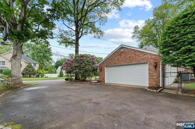 a view of a house with a tree and garage