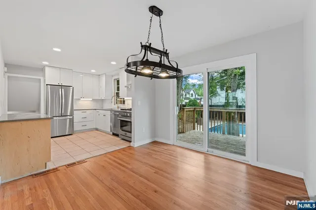 a view of a kitchen with microwave and refrigerator