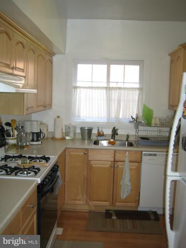 3248 Gunston Road, Unit 724 Alexandria, VA 22302 - Photo 13 of 19 a kitchen with stainless steel appliances granite countertop a stove a sink and a microwave
