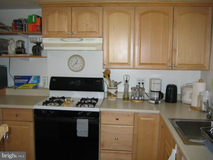 3248 Gunston Road, Unit 724 Alexandria, VA 22302 - Photo 15 of 19 a kitchen with stainless steel appliances granite countertop a sink stove and cabinets