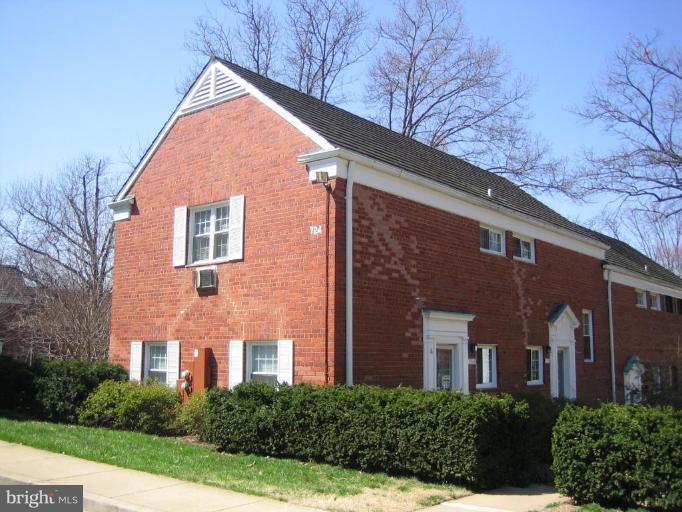 3248 Gunston Road, Unit 724 Alexandria, VA 22302 - Photo 19 of 19 a view of a brick house with yard and plants