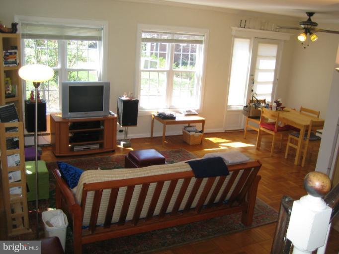 3248 Gunston Road, Unit 724 Alexandria, VA 22302 - Photo 3 of 19 a living room with furniture a flat screen tv and a fireplace