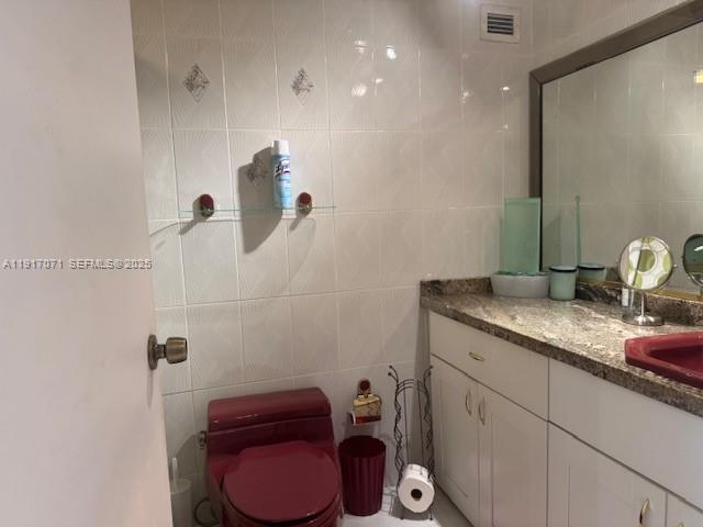 5401 Collins Avenue, Unit 931 Miami Beach, FL 33140 - Photo 17 of 40 a bathroom with a granite countertop sink a toilet and a mirror