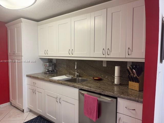 5401 Collins Avenue, Unit 931 Miami Beach, FL 33140 - Photo 24 of 40 a kitchen with granite countertop white cabinets and sink
