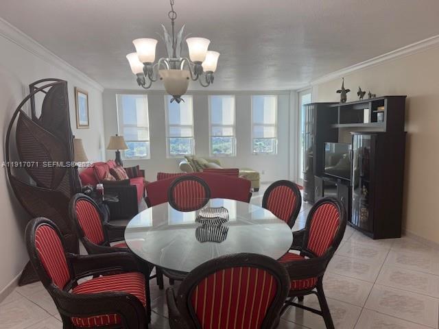 5401 Collins Avenue, Unit 931 Miami Beach, FL 33140 - Photo 26 of 40 a view of a dining room with furniture and chandelier