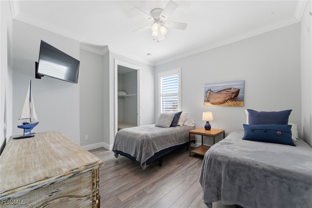 12304 Boat Shell Drive Matlacha Isles, FL 33991 - Photo 29 of 49 a bedroom with two beds and a chandelier