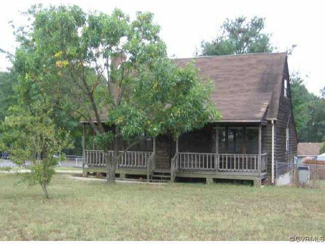 a backyard of a house with washing machine and trees