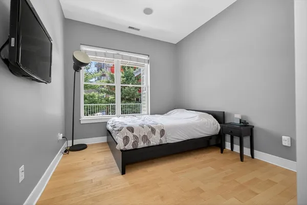 a bed sitting in a bedroom next to a window