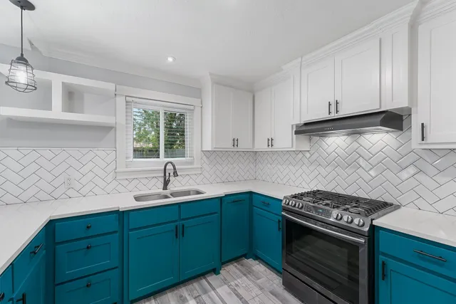 a kitchen with a sink stove and window
