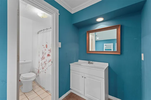 a bathroom with a toilet sink and shower