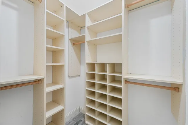 a view of walk in closet with empty racks