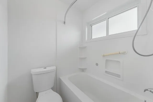 a bathroom with a toilet and a bathtub