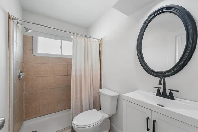 a bathroom with a sink a toilet and a mirror