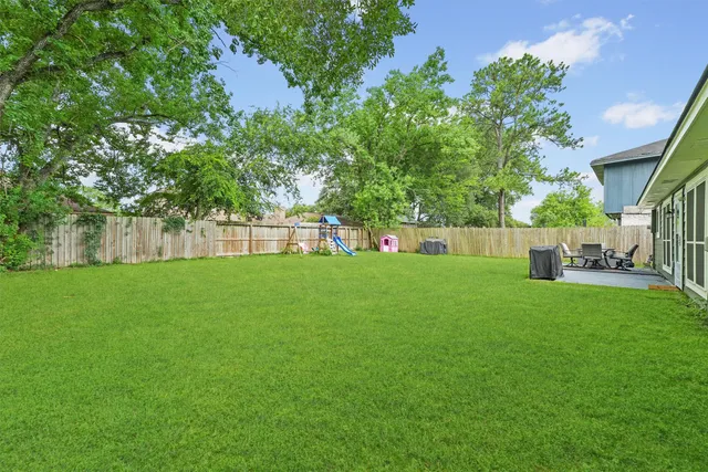 a view of green field with tree in the background