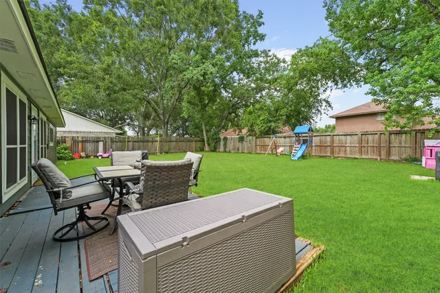a view of a house with backyard sitting area and garden