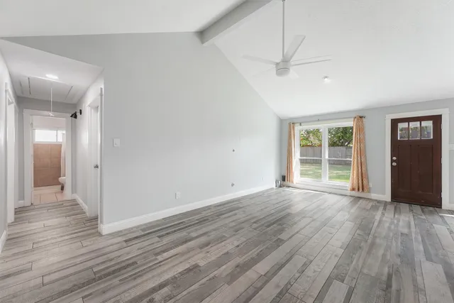 wooden floor in an empty room with a window