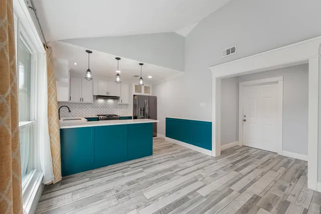 a view of kitchen with wooden floor